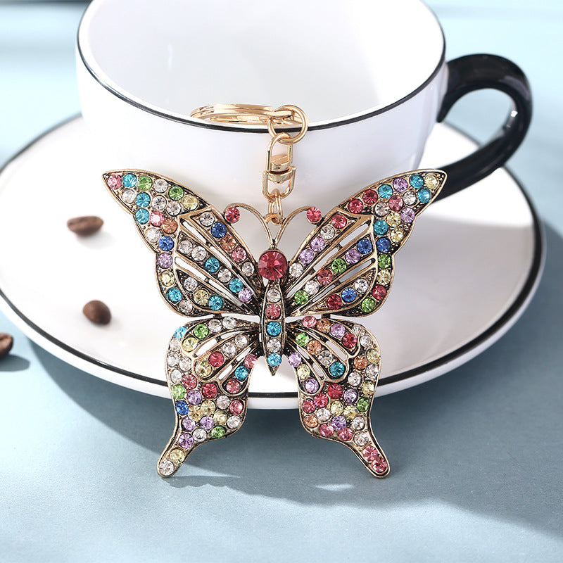 Wholesale color diamond hollow butterfly metal keychain pendant creative small gift bag pendant spot
