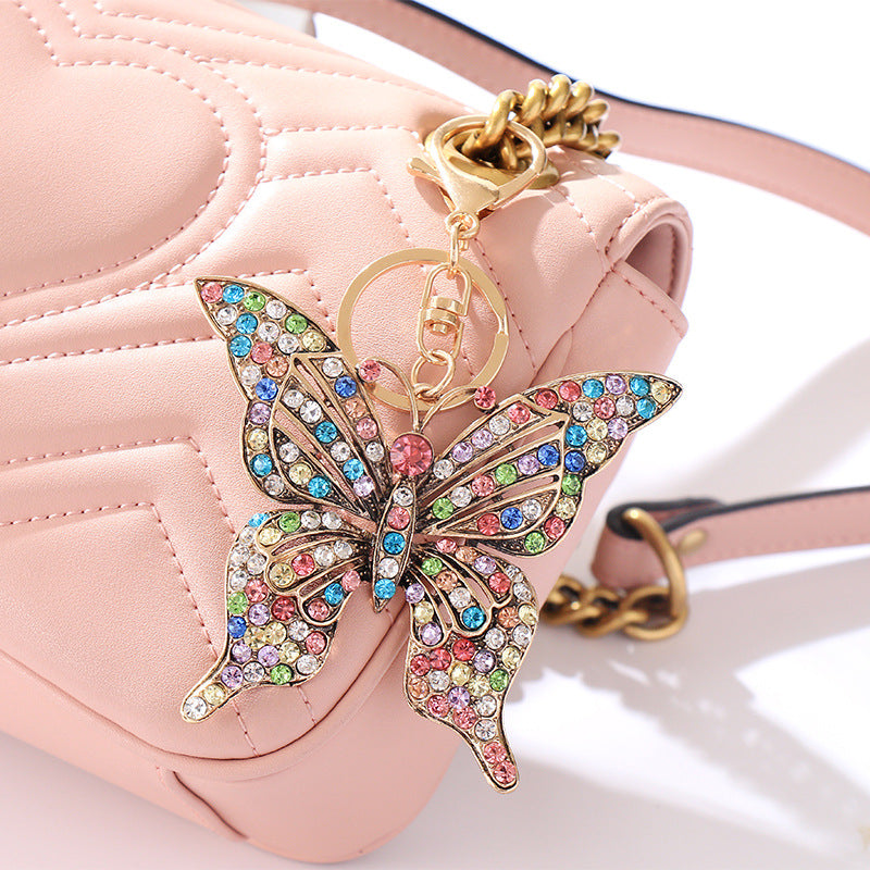 Wholesale color diamond hollow butterfly metal keychain pendant creative small gift bag pendant spot