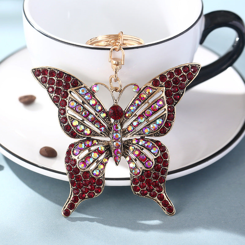 Wholesale color diamond hollow butterfly metal keychain pendant creative small gift bag pendant spot
