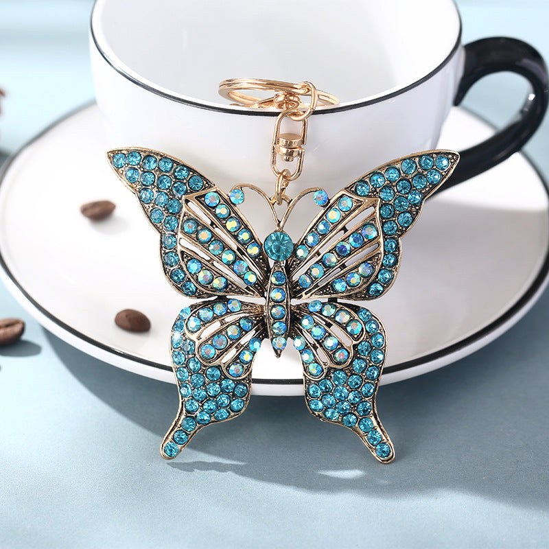 Wholesale color diamond hollow butterfly metal keychain pendant creative small gift bag pendant spot