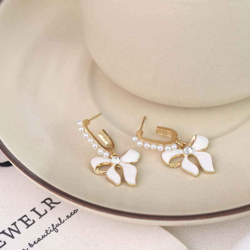 Wholesale White Bow Inlaid Pearl S925 Silver Needle Alloy Earrings ACC-ES-RuLong009