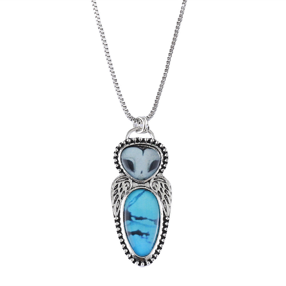 Wholesale Creative punk style owl pendant necklace featuring turquoise inlay and alloy construction.