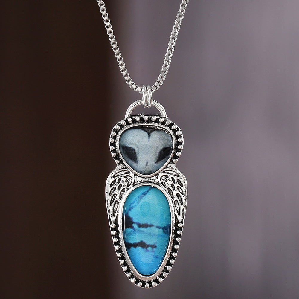 Wholesale Creative punk style owl pendant necklace featuring turquoise inlay and alloy construction.