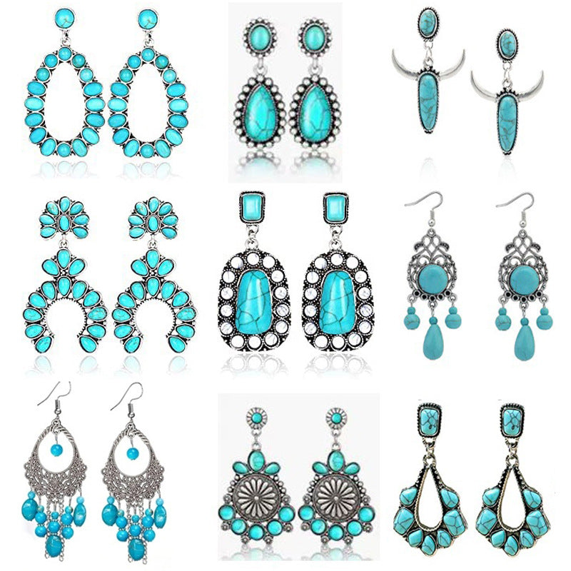 Assorted turquoise-colored drop earrings in varied silver-tone settings