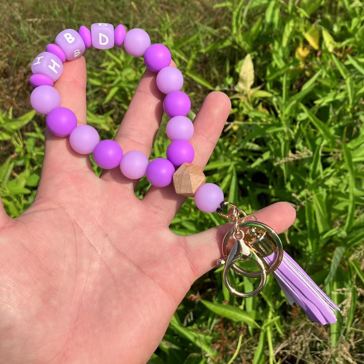 Wholesale Silicone Glow In The Dark Bead Bracelet Keychain With PU Tassels Trendy Car Key Bag Charm Accessory