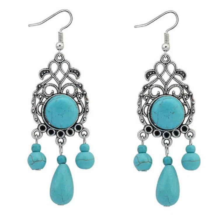 Pair of ornate blue-green drop earrings with silver-tone detailing