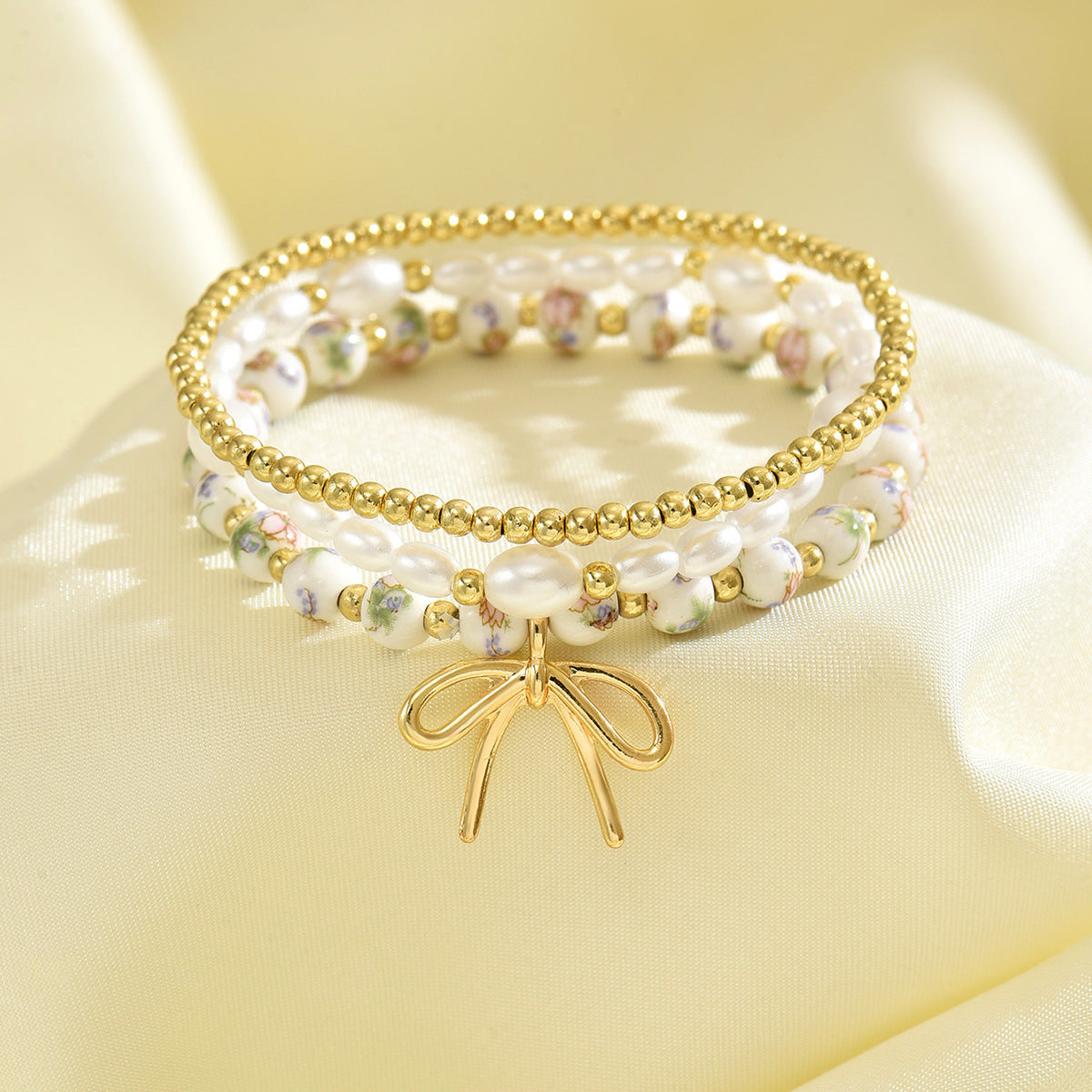 Wholesale Ceramic vintage-style printed bracelet and beaded bracelet set with pearl and butterfly knot pendants