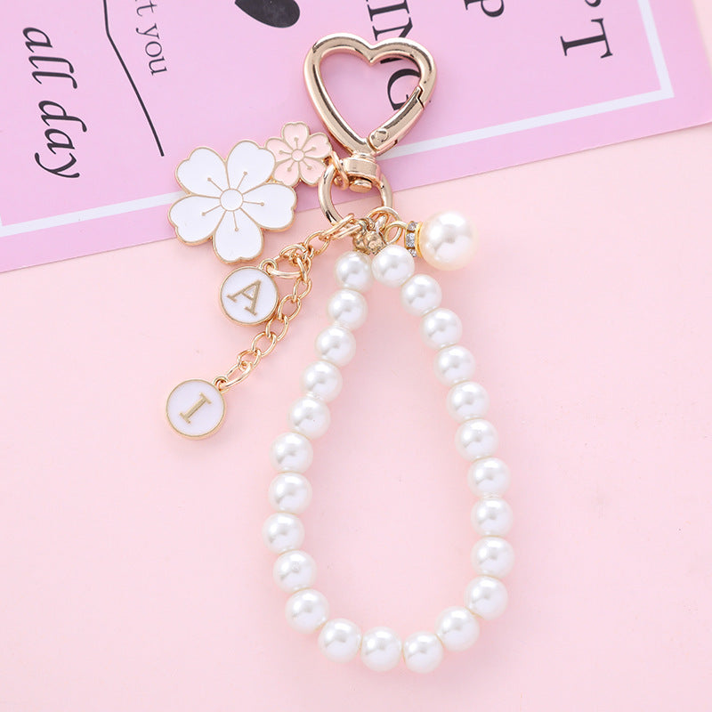 Wholesale two-color flower pearl alloy wrist keychain