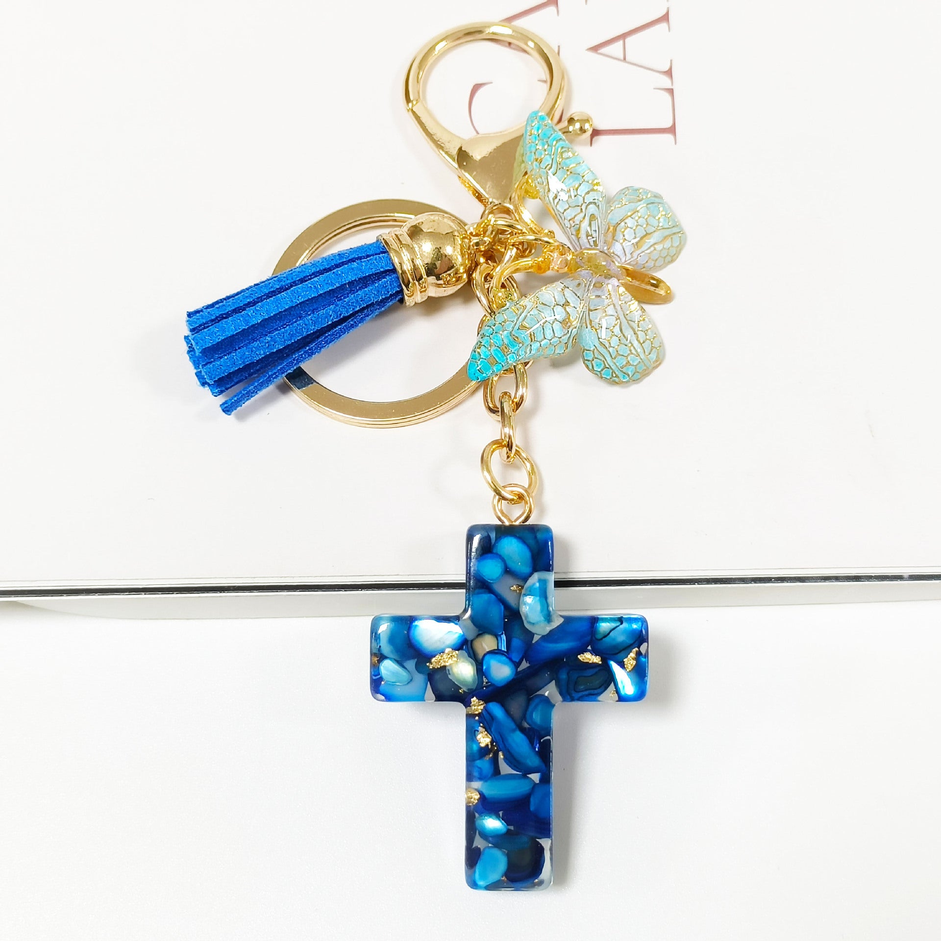 Wholesale Resin glue cross butterfly white blue tassel keychains