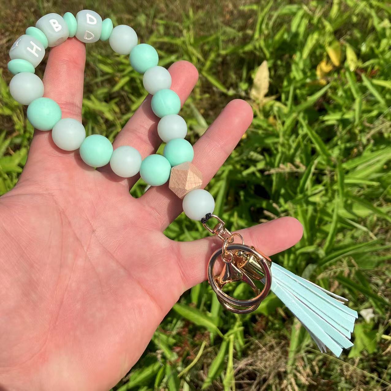 Wholesale Silicone Glow In The Dark Bead Bracelet Keychain With PU Tassels Trendy Car Key Bag Charm Accessory