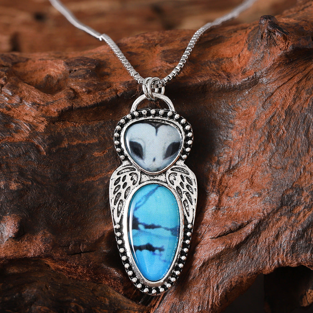 Wholesale Creative punk style owl pendant necklace featuring turquoise inlay and alloy construction.