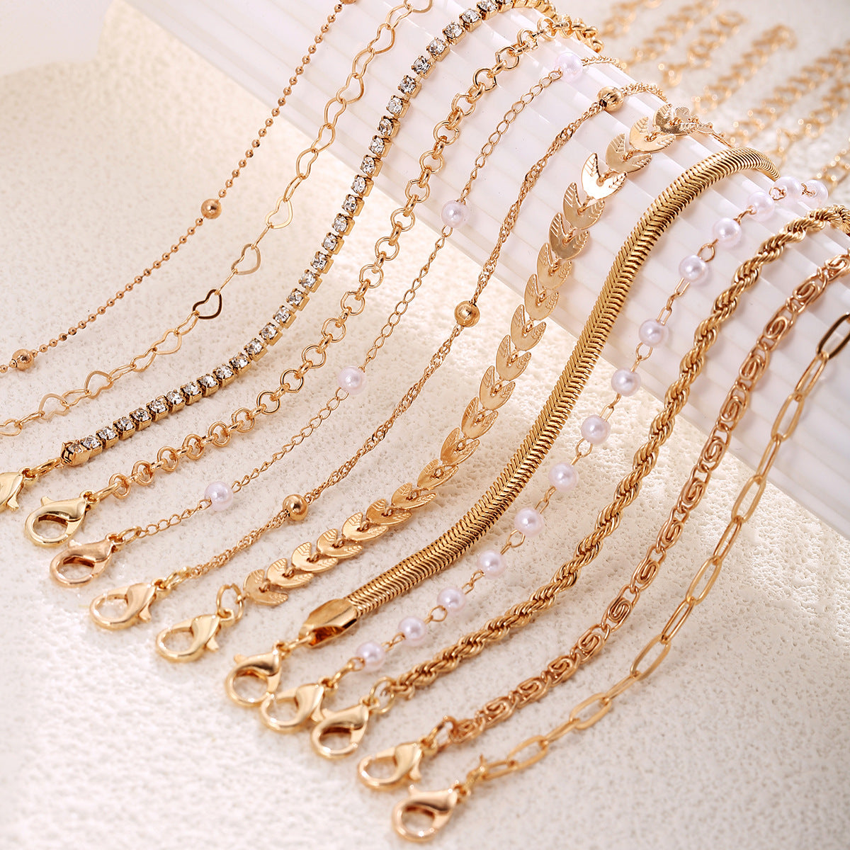 Wholesale Gold Tone 12 Piece Bracelet Set With Airplane Pearl Heart Designs Trendy Resale Jewelry Accessory