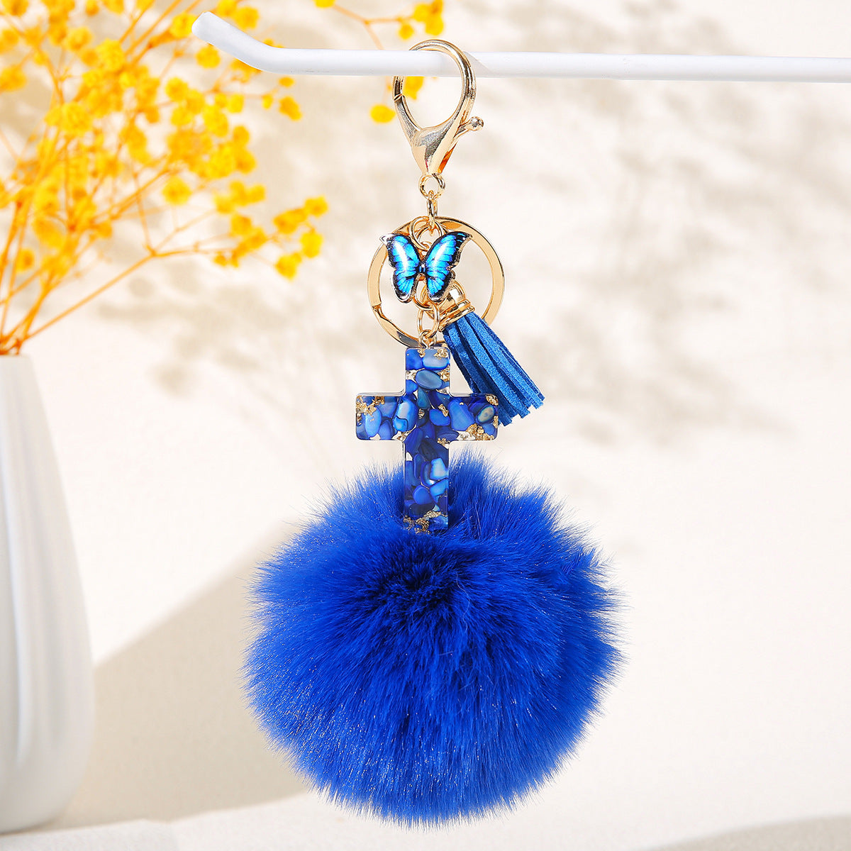 Wholesale Resin butterfly cross keychain with heart-shaped pom-pom