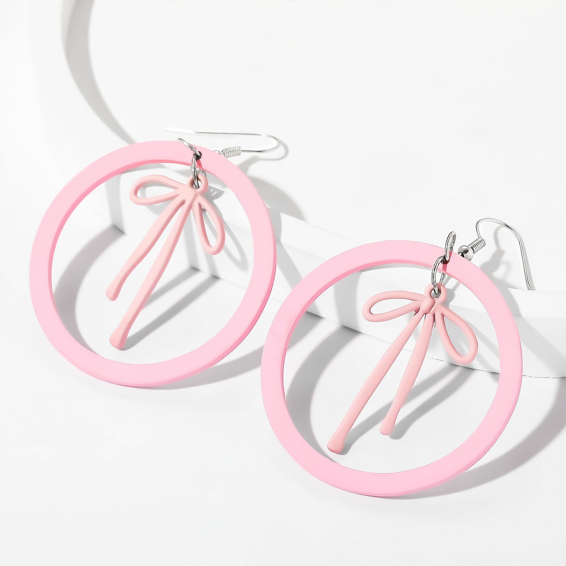 Wholesale acrylic earrings cute pink circle alloy spray-painted bow earrings