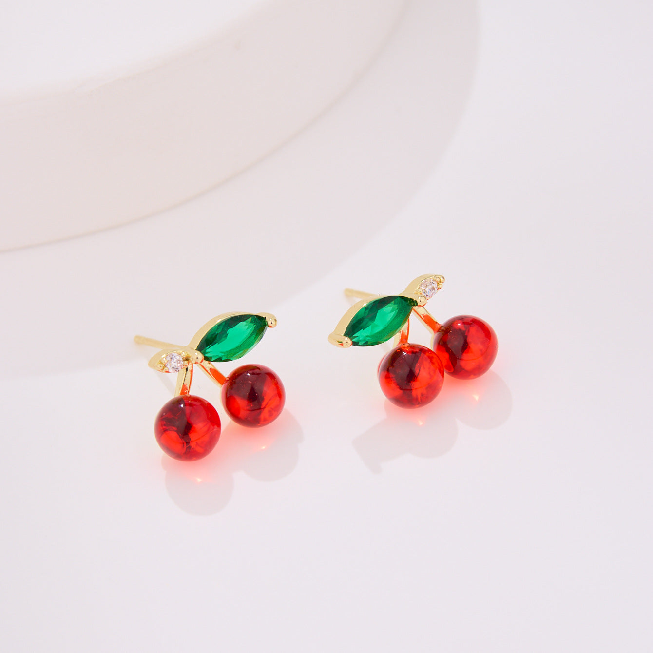 Wholesale copper earrings with diamond-encrusted cherry designs.