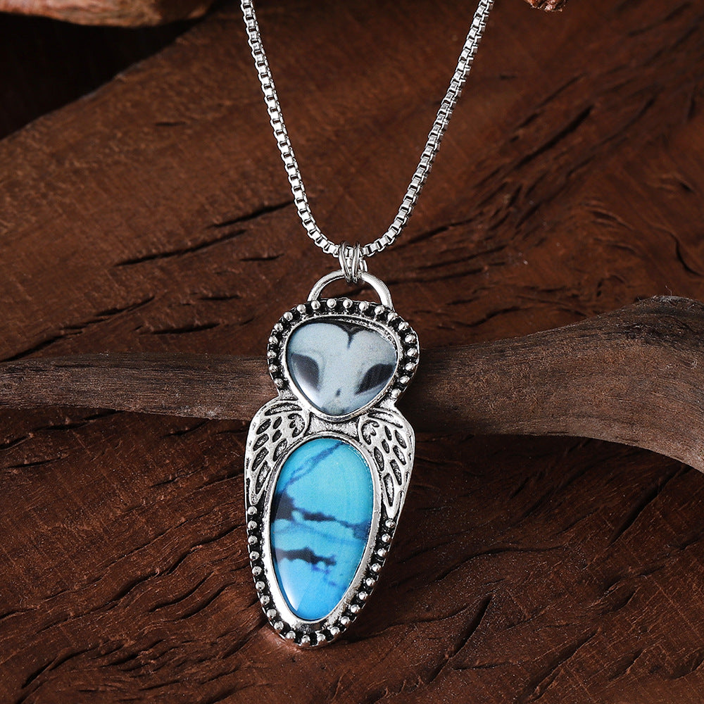 Wholesale Creative punk style owl pendant necklace featuring turquoise inlay and alloy construction.