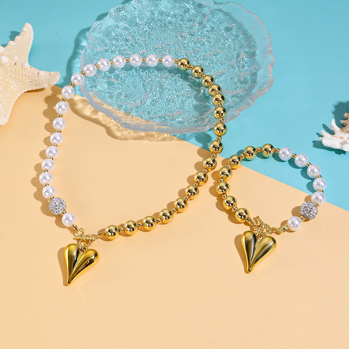 Wholesale  best-selling trendy pearl heart necklace and bracelet set for women  featuring a luxurious and sophisticated ocean-themed design