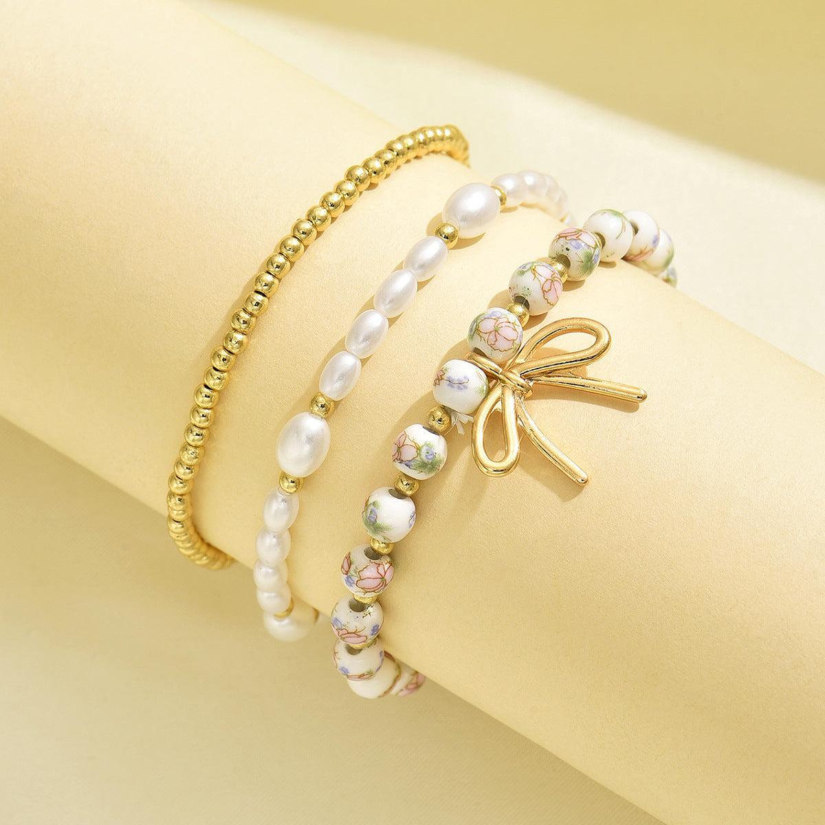 Wholesale Ceramic vintage-style printed bracelet and beaded bracelet set with pearl and butterfly knot pendants