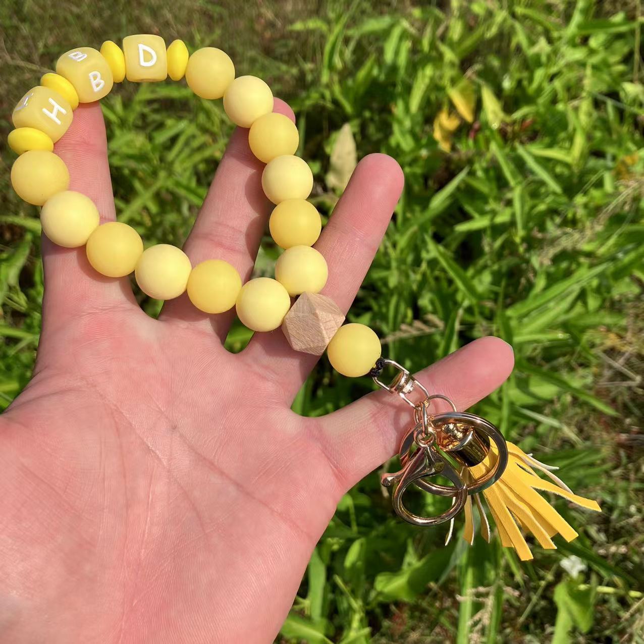 Wholesale Silicone Glow In The Dark Bead Bracelet Keychain With PU Tassels Trendy Car Key Bag Charm Accessory