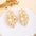 Wholesale Retro Flower Pearl Hollow Love Light Luxury Earrings