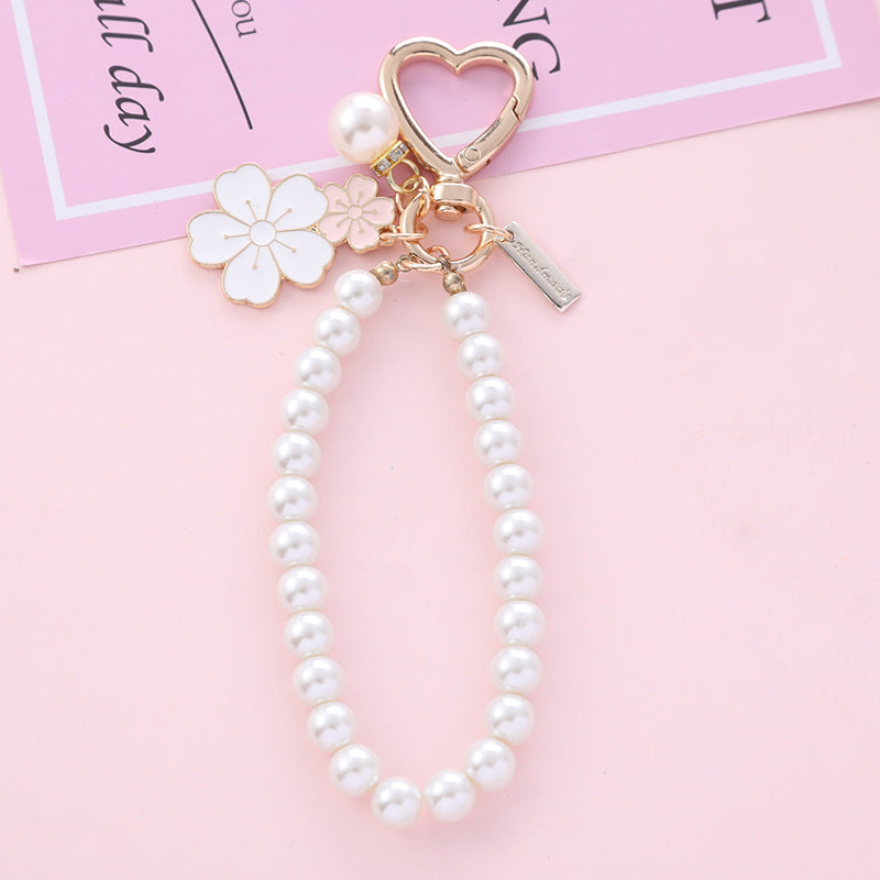 Wholesale two-color flower pearl alloy wrist keychain